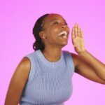 Announcement, rumor and black woman is loud, noise and wow excited isolated in a studio purple background. Young, African American and person share news for promotion and happy with voice